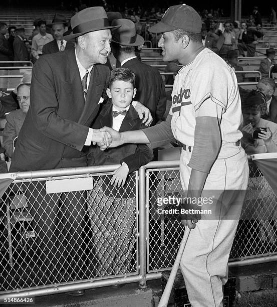 Don Newcombe, the Brooklyn Dodgers starting pitcher for the first game of the 1949 World Series, shakes hands with Hall of Famer Ty Coob. With Cobb...