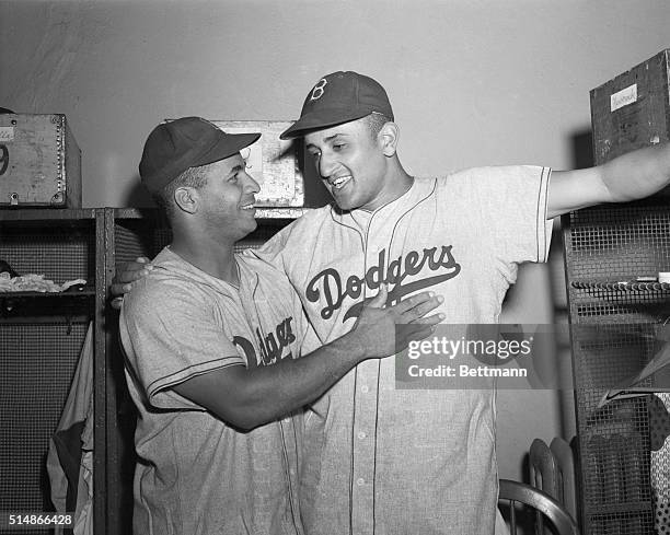 Brooklyn Dodgers catcher Roy Campanella celebrates with Don Newcombe after the pitcher's third straight shutout, a win over the New York Giants.