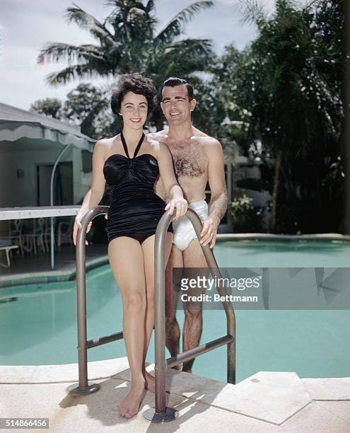 William D. Pawley, Jr. And his fiancee, 17-year-old Elizabeth Taylor, relaxing poolside in August 1949 at the Miami Beach home of Pawley's father, a...