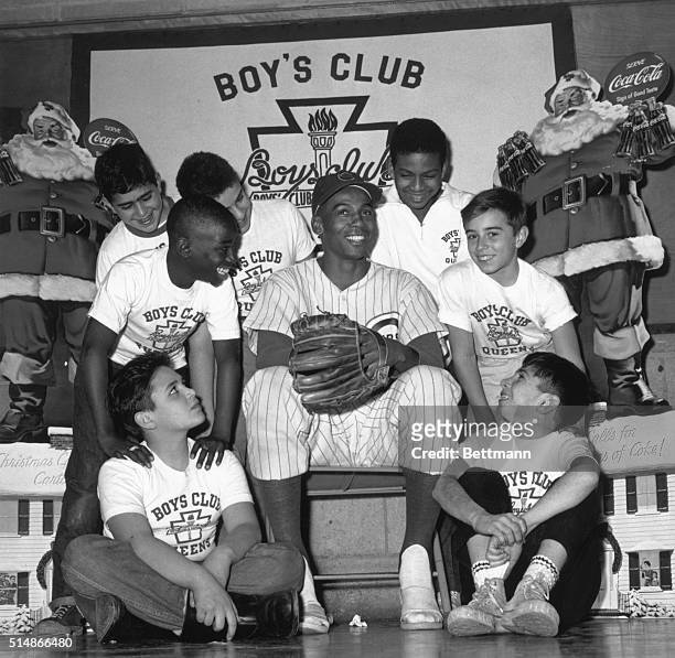 Chicago Cubs shortstop Ernie Banks poses with members of the Long Island City Boys' Club in Queens, New York. Banks is on a speaking tour at Boys'...