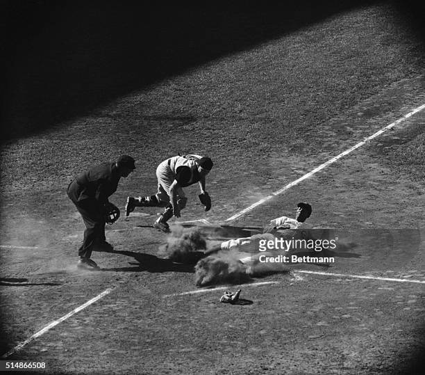 Pirates catcher puts the tag on Ernie Banks at the plate, after the Cubs shortstop tried to score from first on a double.