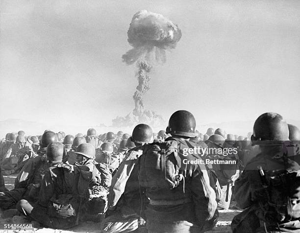11th Airborne division troops watch an atomic explosion at close range at the AEC's testing grounds in the Las Vegas desert. The troops participate...