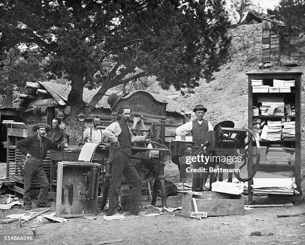 One of the first daily newspapers in New Mexico set up operations underneath a juniper tree near Kingston, New Mexico. | Location: Near Kingston, New...
