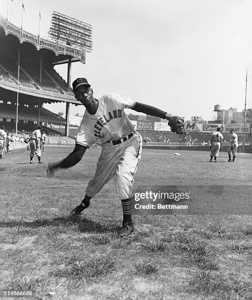 Leroy "Satchel" Paige, a star pitcher in the Negro Leagues for many years, pitches during warmups for the Cleveland Indians. Paige became the first...