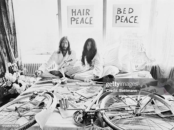 Amsterdam, Holland: Beatle John Lennon and his bride of five days, Yoko Ono, pose in the Presidential Suite of the Amsterdam Hilton Hotel, March...