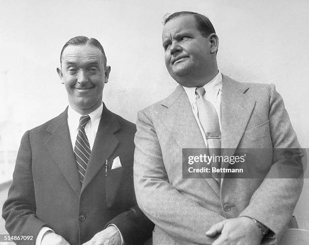 Stan Laurel and Oliver Hardy on board a ship on their vacation together. Stan Laurel looking comical as his film character, and Oliver Hardy looking...