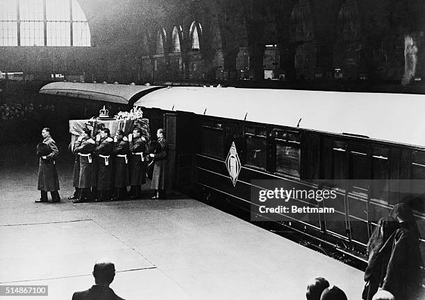 London, England: Guardsmen pallbearers are carrying te coffin of King George VI from the train that bore it from Sandringham to London. The coffin is...