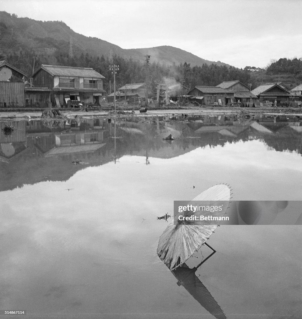 Flooded City With Umbrella In Foreground