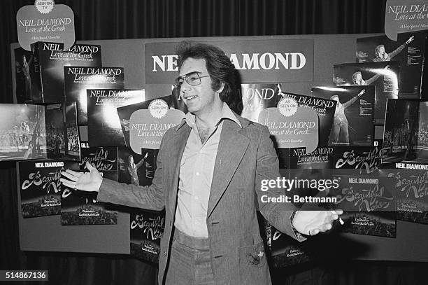 Neil Diamond greets members of the press at the London International Hotel, standing in front of a display for his albums Love at the Greek and...