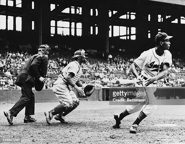 Cleveland, OH: Pinchhitter Larry Doby of the Cleveland Indians heads for first base afterf batting for pitcher Red Embree in the Indians-Philadelphia...