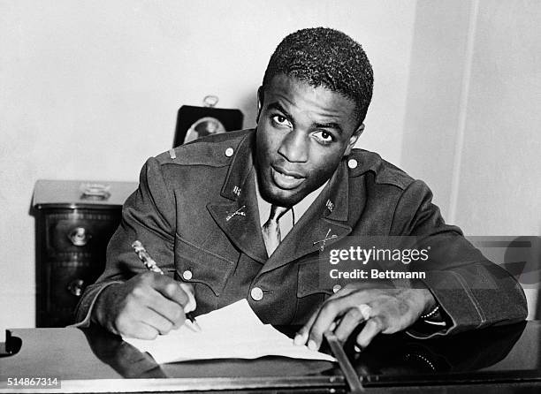 Jackie Robinson, in military uniform, becomes the first African American to sign with a white professional baseball team. He signs a contract with...