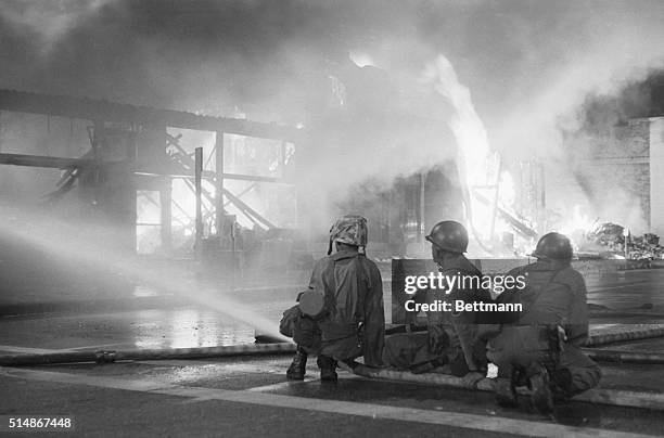 Los Angeles: National Guard soldiers man the fire hoses into the night, helping out hard-pressed firemen faced with dozens of major blazes set by...