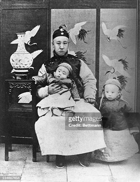 Prince Chun Tsai Feng with two sons, Pu-yi, standing, and Hzuan T'ung . Undated photograph.
