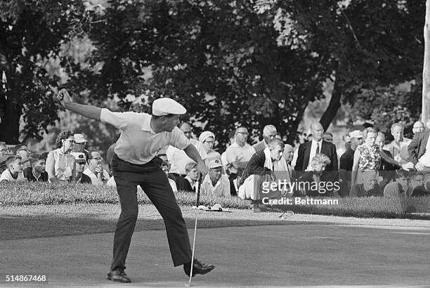 Baltimore, MD: Clive Clark watches his 34-foot putt sink on the 18th hole to save the British from a humiliating defeat in the Walker Cup matches....