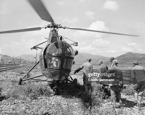 Korea: A wounded marine being loaded into a helicopter for evacuation to rear.