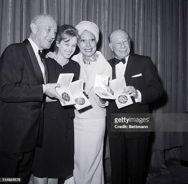 New York, NY: Winning Broadway stars display their trophies at the 1963-64 Tony Awards presentation . Left to Right are: Sir Alec Guinness, best...