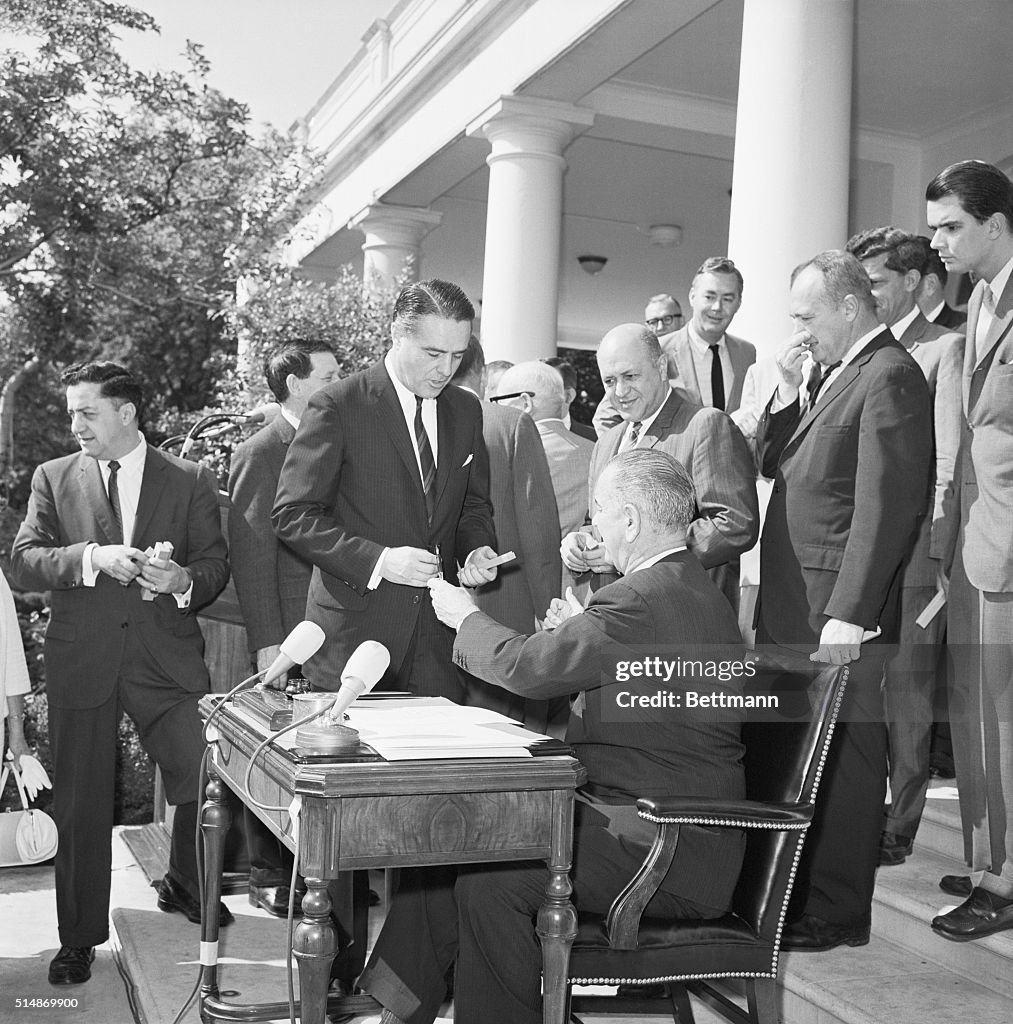 President After Signing War On Poverty