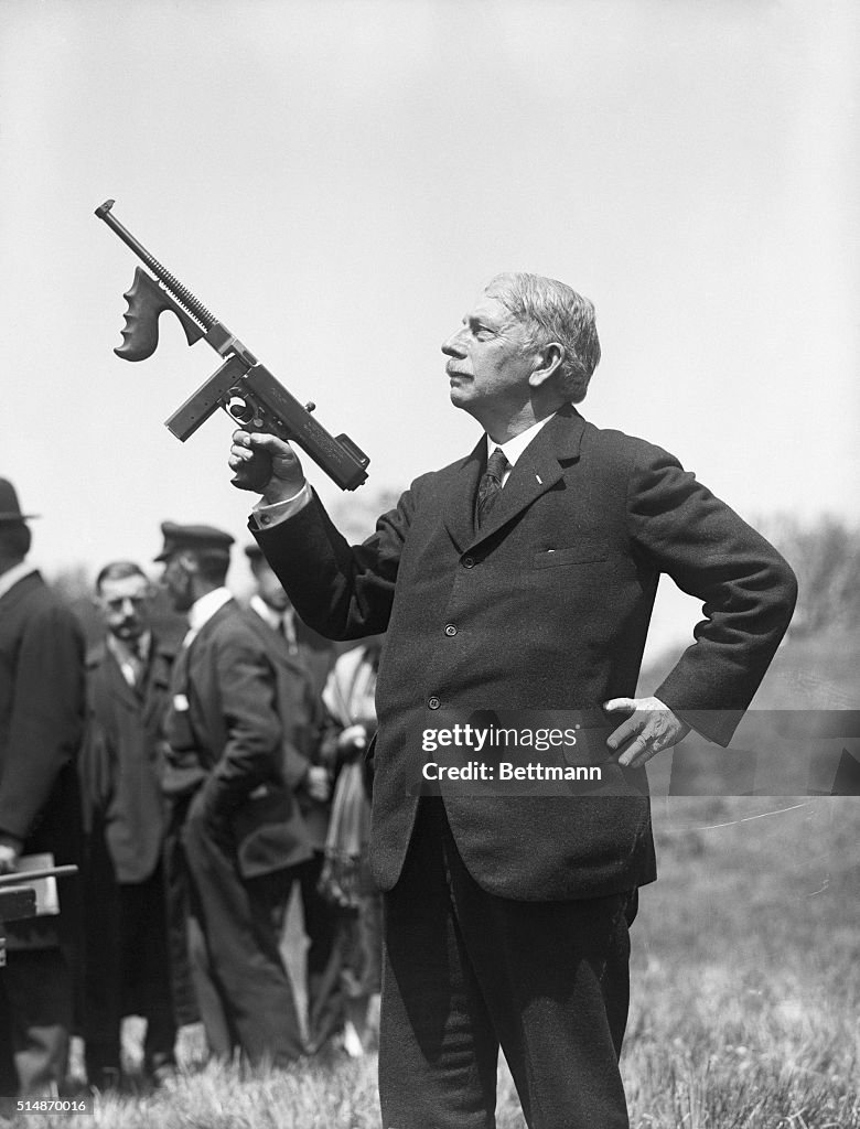 John Thompson Holding Machine Gun
