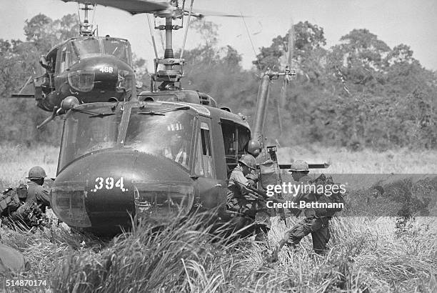 Near Firebase Crossed Sabers, South Vietnam: United States 1st Air Cavalry troopers make a dash for the helicopter as they prepare to pull out of the...