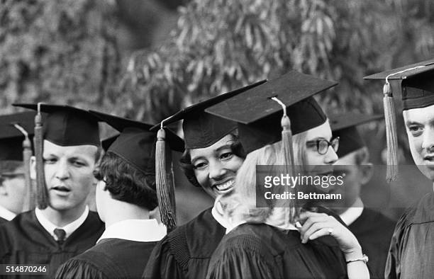 Tuscaloosa, AL: Vivian Malone, breaks in to a grin as she jokes classmate prior to her graduation from the University of Alabama.