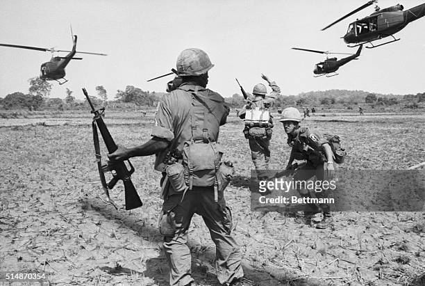 Bien Hoa, South Vietnam: United States paratroopers spread out after disembarking from helicopters during a co-ordinated exercise, the first in which...