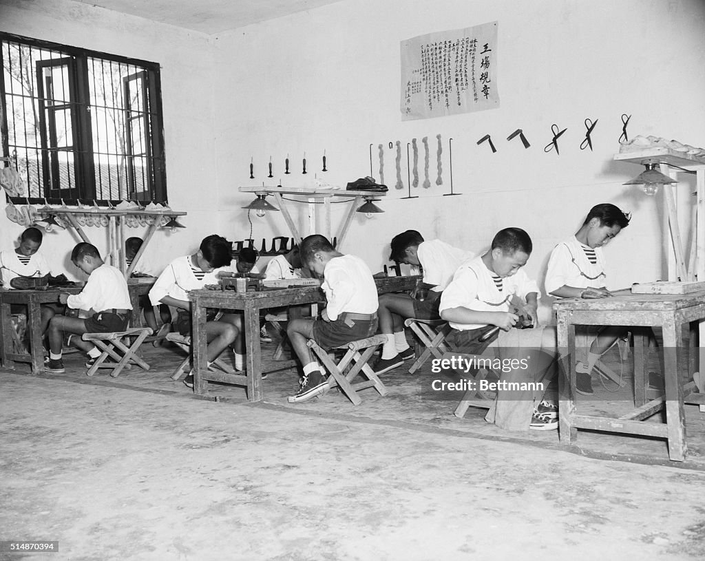 Boys Seated At Tables Making Shoes