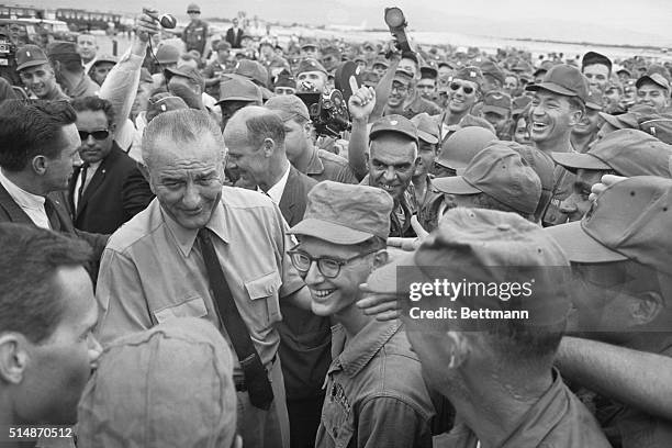 Cam Ranh, Vietnam: Cheering Us soldiers surround President Johnson as he arrives on an un-announced visit to Atherton.