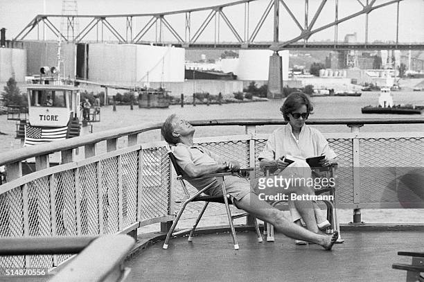 Dubuque, IA: President Jimmy Carter and his wife Rosalynn relax in the sun aboard the riverboat The Delta Queen August 20 after the craft left...