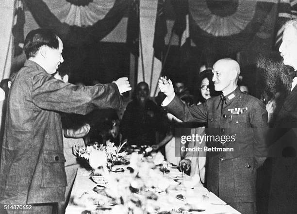During a welcoming party for Mao Zedong, General Chiang Kai-shek toasts with Mao over the banquet table.