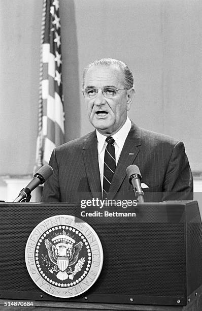 Washington, D.C.: President Lyndon B. Johnson reads a statement at the White House dealing with the message he sent to the House and Senate the same...