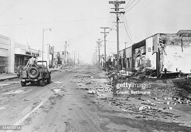 National Guard jeep patrols the Watts section of Los Angeles after six days of riots, 18th August 1965.