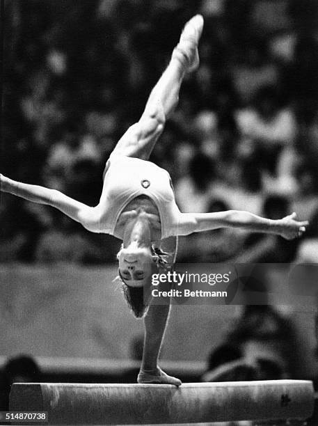 Romanian gymnast Nadia Comaneci performs on the balance beam during the women's individual overall competition at the World Cup Gymnastics...