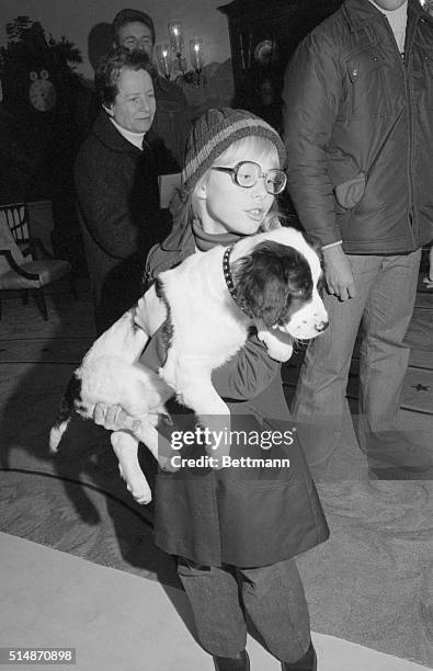 Washington, D.C.: Amy Carter holds her new puppy, Grits, which was presented to her at the White House. The twelve-week-old black and white puppy,...