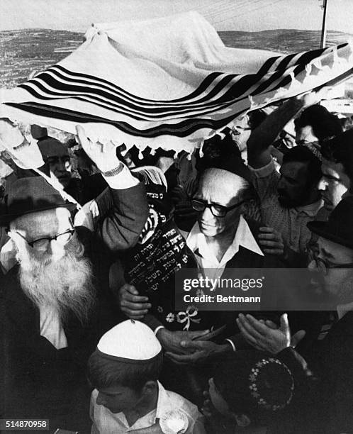 Kadum, Israeli-occupied Jordan: Victorius Likud party leader Menachem Begin carries new Torah scroll in ceremony at an unauthorized Jewish settlement...