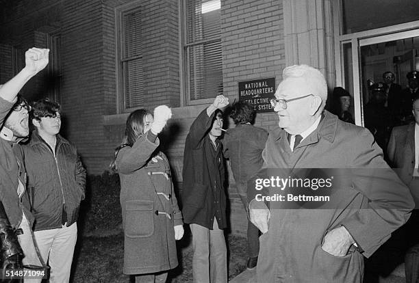 Washington, DC: Lt. Gen. Lewis Hershey is greeted by a small group of protesters as he leaves the Selective Service Headquarters Dec. 1 after the...