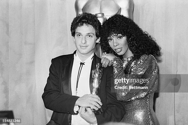 Hollywood, CA: Paul Jabara, holding his Oscar for Best Original Song , poses with singer Donna Summer, who sang the song at the Academy Awards show.