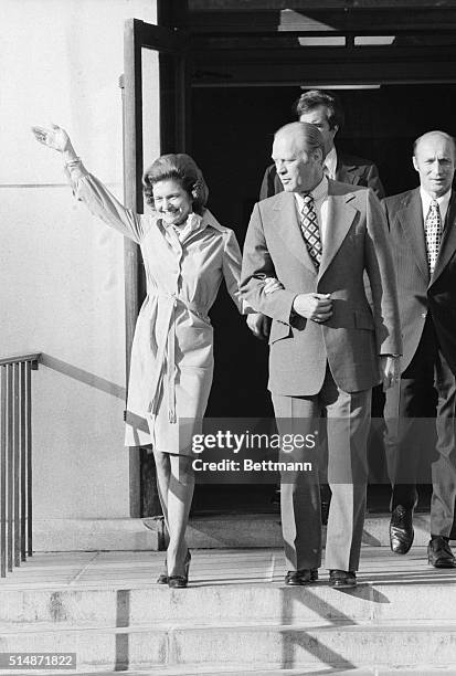 Washington, D.C.: Photo shows President Gerald Ford assisting his wife, Betty, down the stairs as she left for Bethesda Naval Hospital recently,...