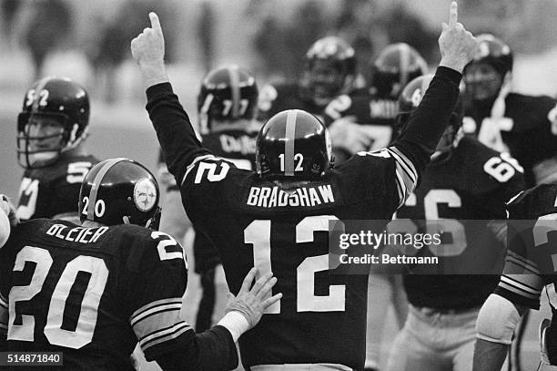 Pittsburgh, PA: On his way off the field, Steeler quarterback Terry Bradshaw, No. 12, sums up his feelings about leading the Steelers to a 27 to 13...