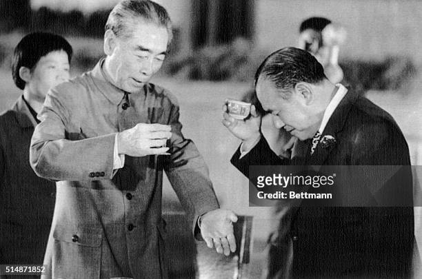 Peking, China: Japanese Prime Minister Kakuel Tanaka bows head and raises cup of Sake as he drinks toast with Chinese Premier Chou En-lai during...