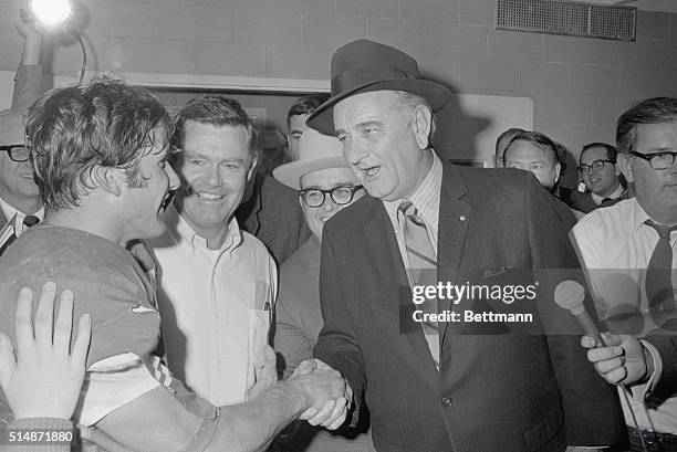 Dallas, TX: Former President Lyndon B. Johnson, now retired on his ranch near Austin, congratulates winning quarterback James Street and head coach...