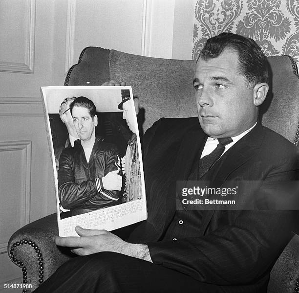 Prominent defense attorney F. Lee Bailey holds a photo of his client Albert De Salvo, the Boston Strangler, during his capture after an escape.