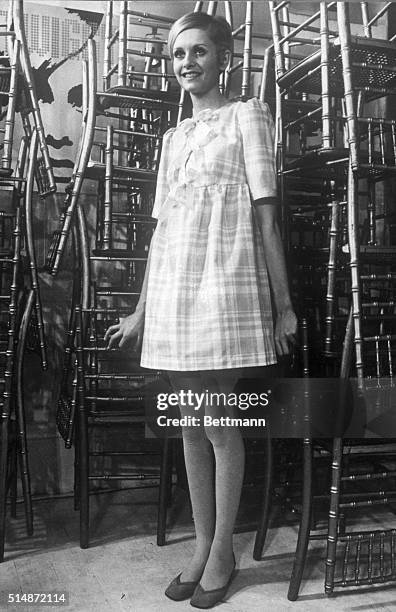 Internationally-famed British fashion model Twiggy shows off a cotton voile summer party mini-dress February 16 which will sell here for about $17...