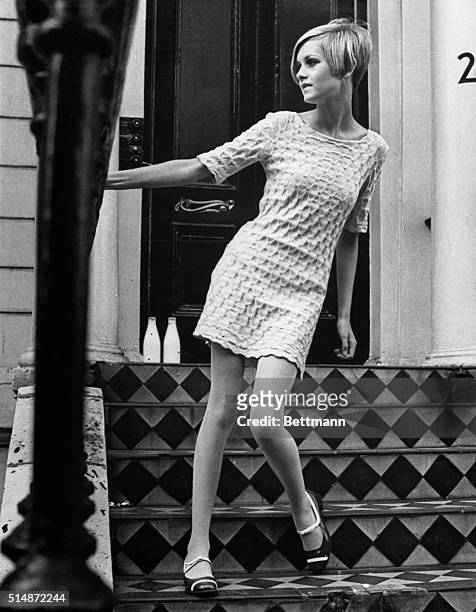 London: Fashion's newest sensation, 17 yr-old Lesley "Twiggy" Hornby strikes a pose on a doorstep. Twiggy, who still lives with her parents in North...