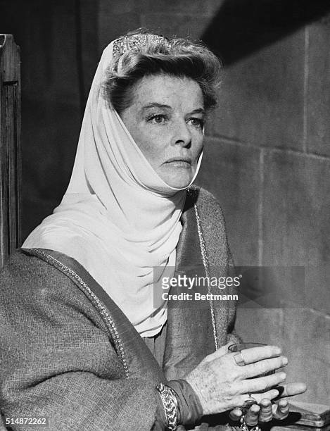 Portraying Queen Eleanor of Aquitaine, Katharine Hepburn is caught in a thoughtful mood during a scene in The Lion in Winter.