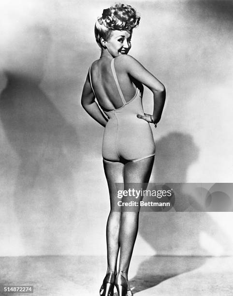 Popular American movie actress Betty Grable models a bathing suit in the most famous pinup photo of World War II.