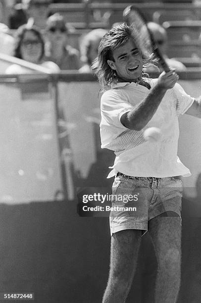 Fourth-seeded Andre Agassi returns a forehand to Philip Johnson in an opening round match at the US Open. Flushing Meadow, New York.