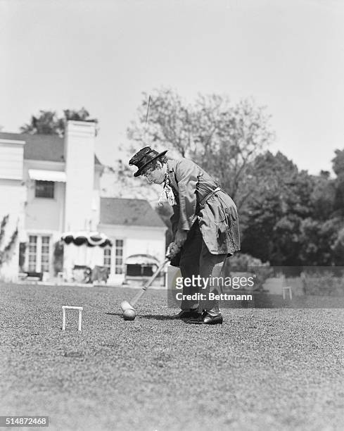 Harpo Marx scores in a furious game of croquet, his favorite exercise which kept him in perfect physical trim for his feats in the new Marx Brother's...
