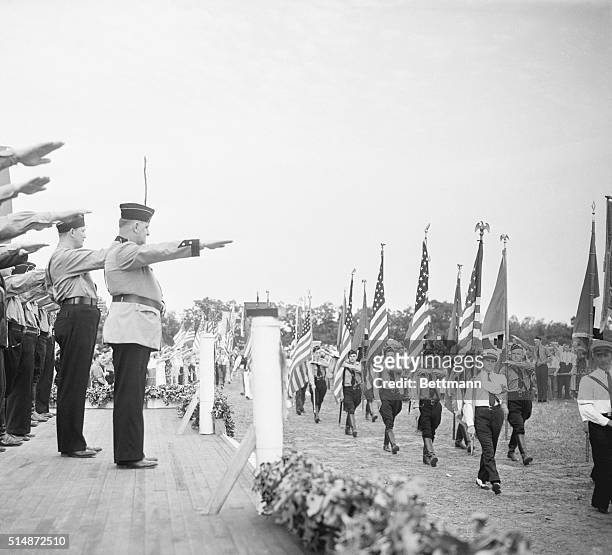 The leaders of German American Bund give the Nazi salute to young men and women marching in Nazi uniforms. The event was a German Day celebration...