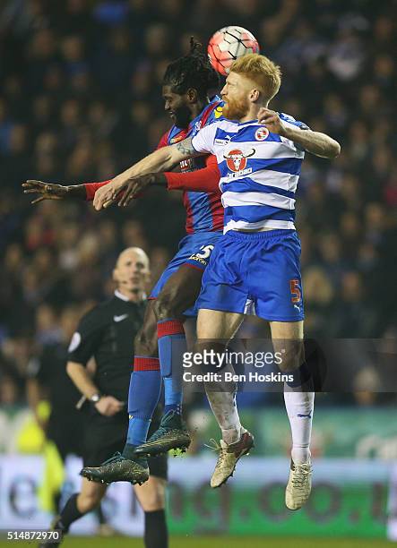Paul McShane of Reading and Emmanuel Adebayor of Crystal Palace jump for the ball during the Emirates FA Cup sixth round match between Reading and...