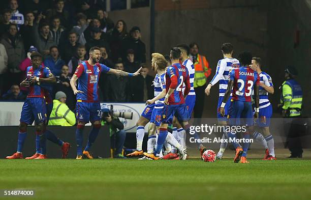 Wilfried Zaha of Crystal Palace is restrained as players argue during the Emirates FA Cup sixth round match between Reading and Crystal Palace at...